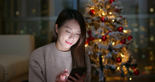 Woman send blessing message on cellphone in christmas 