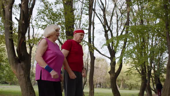 Sporty Mature Couple Family Jogging Together. Senior Husband and Wife Doing Cardio Workout Exercises