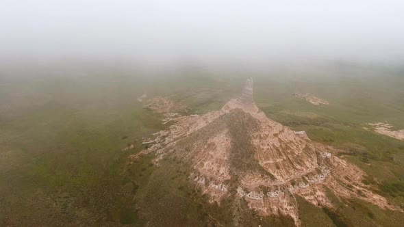 Drone shot of rock formation in grassland of Chimney Rock National Historic Site in Nebraska, USA