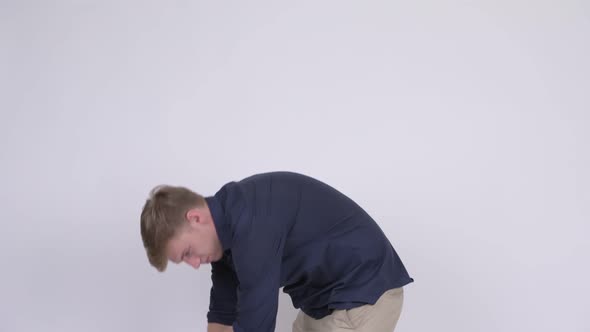 Young Stressed Blonde Businessman Having Back Pain