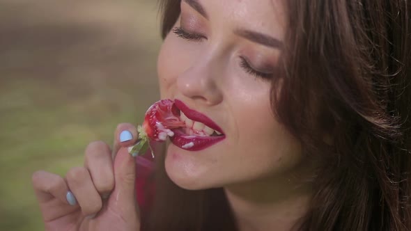 Pretty Woman Seductively Eating Strawberries