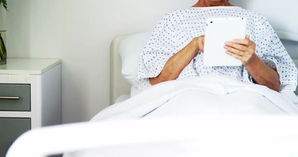 Female patient using digital tablet in the ward