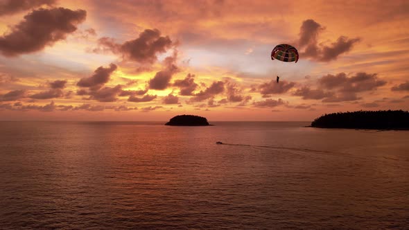 Parasailing at an Orange Sunset on the Beach