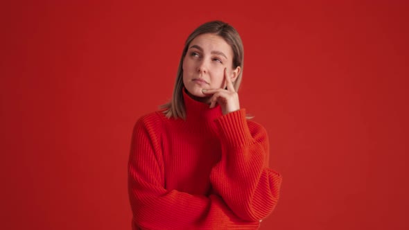 Positive woman wearing red sweater having idea