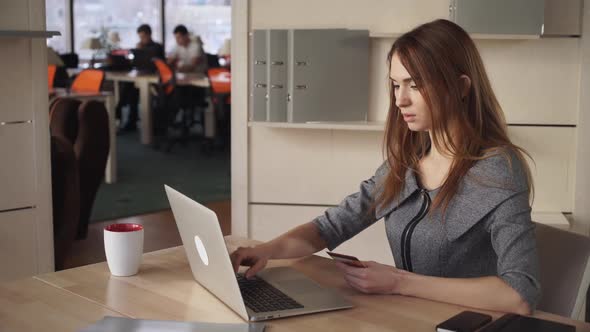 Online Banking. Beautiful Woman Pay By Credit Card At The Working Place 