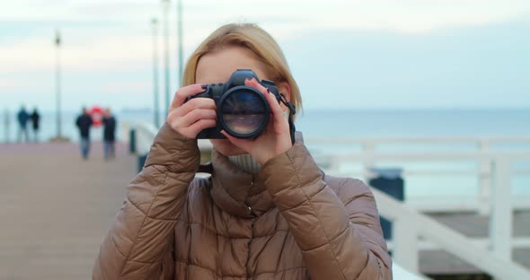 Professional Female Photographer Takes Pictures of the Sea