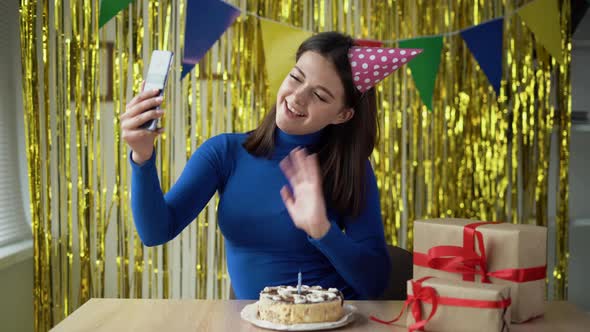 Birthday Live on the Phone Camera of a Cheerful Girl Tells and Shows Gifts and a Birthday Cake