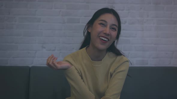 Woman Laughing While Watching Television