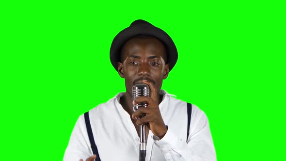 Male African American Musician Singing in a Recording Studio. Green Screen. Close Up