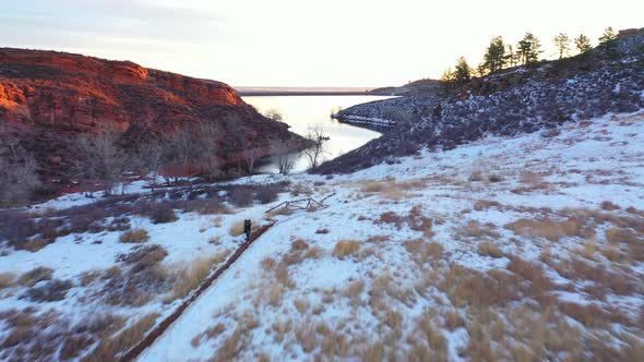 Red Rocks in Winter Colorado Snow Covered. Sunrise over distant peaks in Snowy Moraine Park Colorado