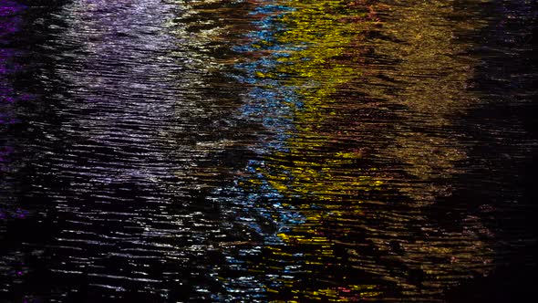 The night sea reflects the bright street light