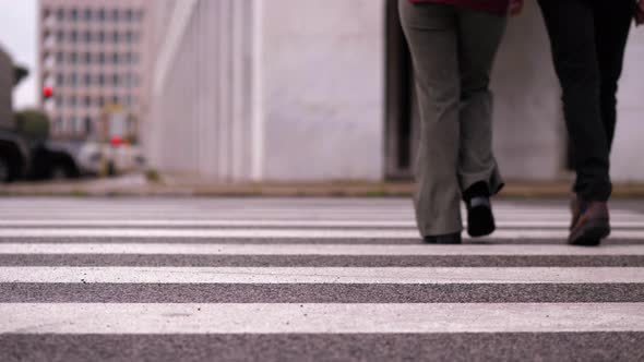 help, support - young man helps his friend with a disability to cross the street