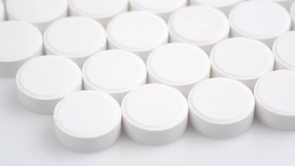 Many White Medical Pills Rotating Close Up