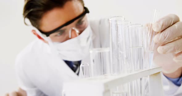 Lab technician checking sample in tube