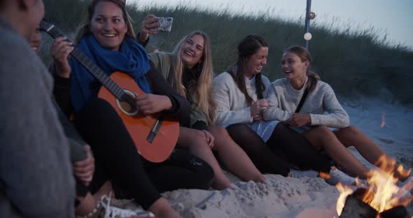 Beautiful Ladies Sitting By the Bonfire By the Beach