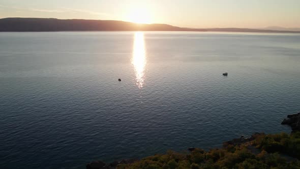 Aerial View of Landscape Sunset Over the Sea Leaves Trail and Glare on the Water