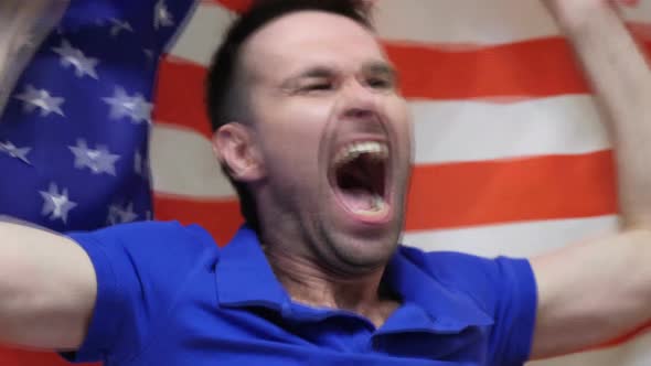 American Fan Celebrating While Holding the Flag of America