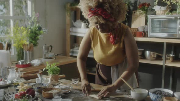 African American Woman Preparing Pastry in Kitchen