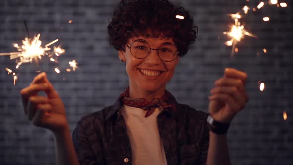 Slow Motion of Joyful Girl Holding Bengal Lights Smiling Looking at Camera