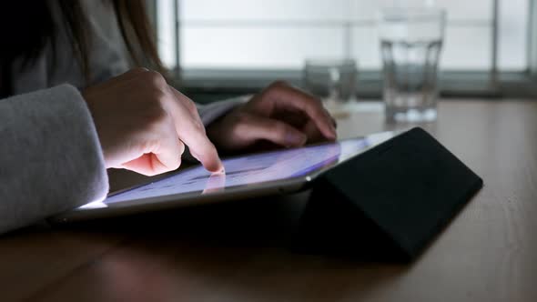 Woman using tablet computer at home