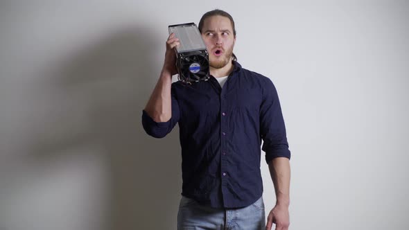 a Guy with an Athletic Build an Athlete Holds a Mining Farm on His Shoulder Fooling Around