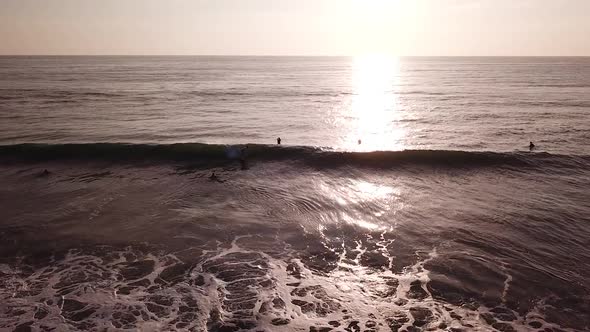 Bright Sunlight Falling On Sea Surface With Tourist Surfers In Olon Beach, Ecuador. - Aerial Shot