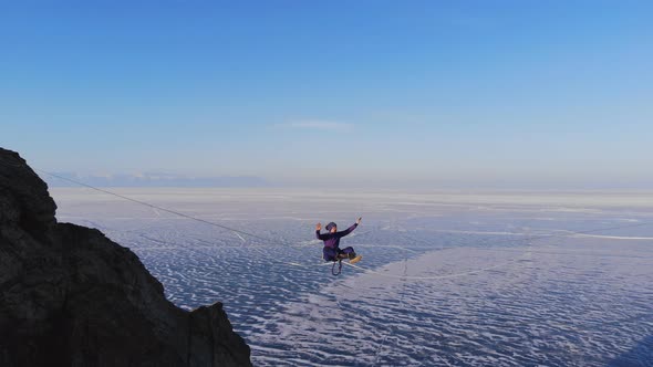 Young Woman on the Highline, Tightrope Walker Doing Yoga at High Altitude