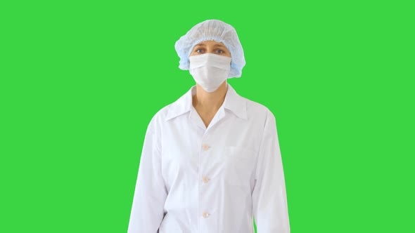 Walking Female Doctor Wearing Surgical Mask on a Green Screen, Chroma Key