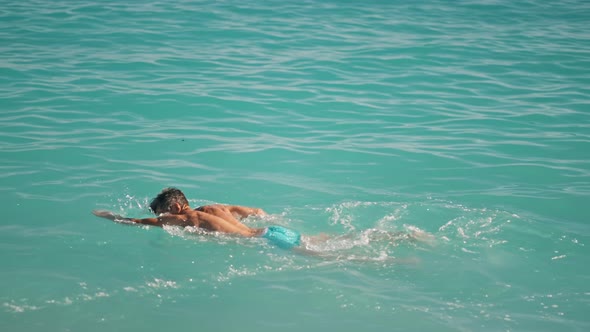 Slow Motion Sportsman Athletic Man Swims in Turquoise Water of Mediterranean Sea in Oludeniz Beach