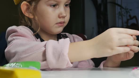 a Cute Preschooler Molded a Small Carrot From Plasticine Holds in Her Hand