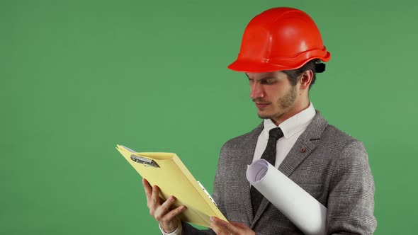 Bearded Male Engineer Looking Confused While Reading Documents