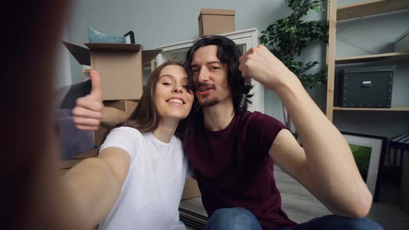 POV of Husband and Wife Taking Selfie with New Flat Keys Kissing and Posing