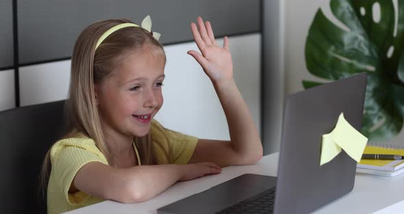 Caucasian Little Girl School Pupil Studying Online From Home Watching Web Class Lesson or Listening