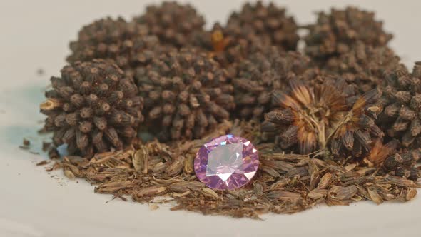 Pink Amethyst Diamonds In A Pile Of Kratom Seeds.