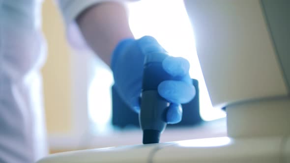 Doctor is Operating a Joystick of a Medical Machine