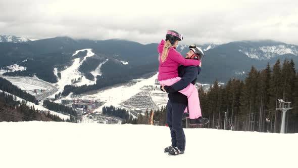 Loving Couple in Sporty Wearing on Mountain at Ski Resort