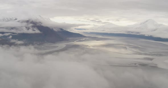 Aerial footage through Alaskan valley towards mountains, drone helicopter footage