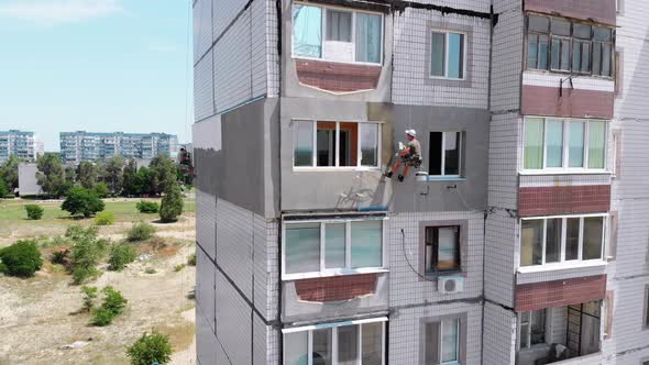 Aerial View Two Industrial Climbers Perform Work on Insulation Facade Building