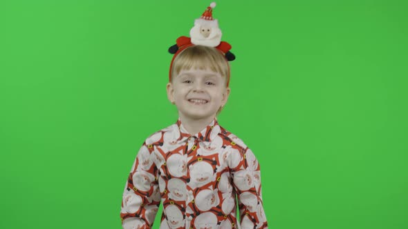 Happy Beautiful Little Girl in a Shirt with a Santa Claus