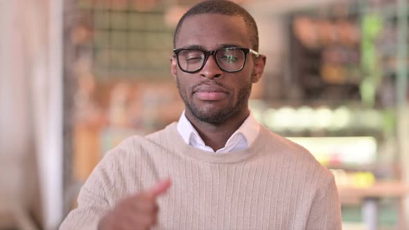 Portrait of Disappointed African Man Doing Thumbs Down