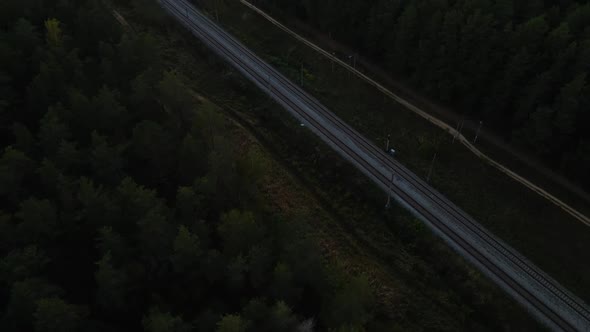 Aerial View: Pan Up Over Railroad Without Train at Night