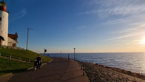 Winter in Urk with the Dike and Beach By the Lighthouse of Urk Snow Covered During Winter Sunset By