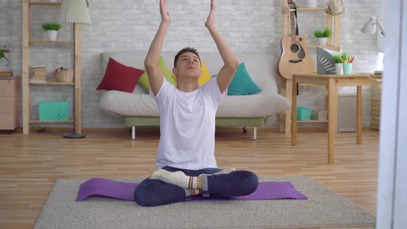 Young Korean Man Doing Yoga Sitting on the Mat