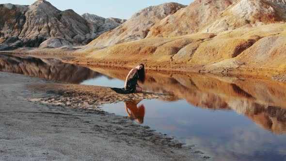 Beautiful woman posing on other-worldly hilly landscape