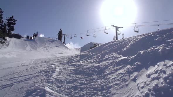 A young man snowboarding down a snow covered mountain.