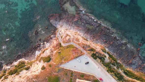 Aerial drone view of coastline and turquoise crystal clear water in Sardinia, Italy