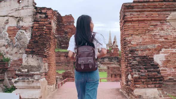 Japanese backpacker female enjoy her journey at amazing landmark in traditional city.