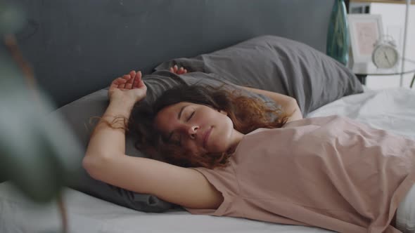 Young Woman Falling Down and Sleeping on Bed