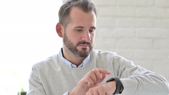 Portrait of Young Man Using Smart Watch 