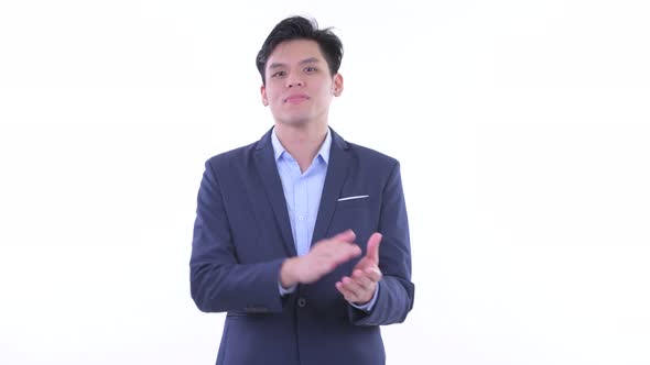 Happy Young Asian Businessman Clapping Hands